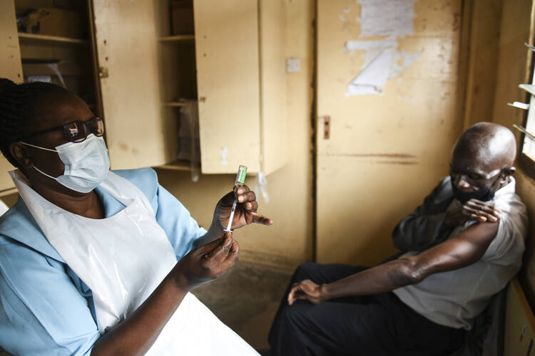 A man prepares for his AstraZeneca COVID-19 vaccine at Ndirande Health Centre in Blantyre, Malawi on March 29. (AP Photo/Thoko Chikondi, File)