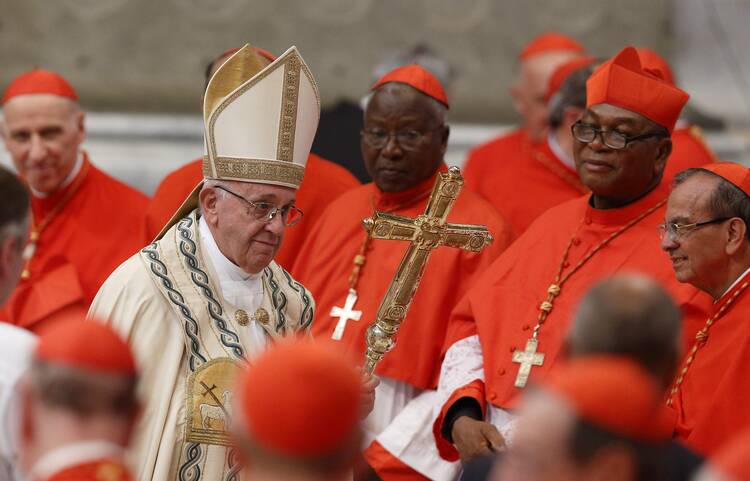 Pope Francis leaves after a consistory to create 14 new cardinals in St. Peter's Basilica at the Vatican in this June 28, 2018, file photo. The pope has updated rules for the Vatican court system so that cardinals and bishops accused of a crime can now be tried by the Vatican City court, just like priests and laypeople can be. (CNS photo/Paul Haring)