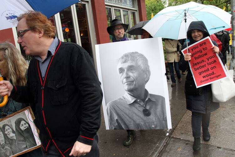 Mourners participate in a peace march May 6, 2016 prior to the funeral Mass of Jesuit Father Daniel Berrigan at the Church of St. Francis Xavier in the Greenwich Village neighborhood of New York City. Father Berrigan, a peace and social justice activist, died April 30 at age 94. (CNS photo/Gregory A. Shemitz) 