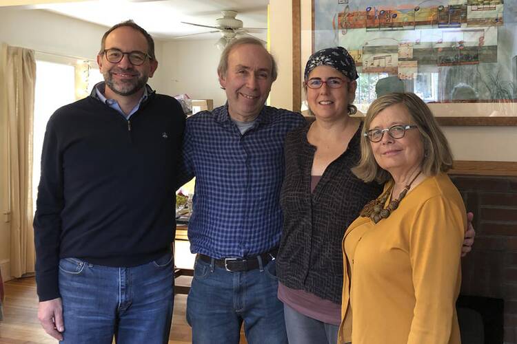 Associated Press Religion Writer Rachel Zoll, second from right, receives a visit in Amherst, Mass., on Oct. 26, 2018, from Managing Editor Brian J. Carovillano, editor at large Jerry Schwartz, and Deputy Managing Editor Sarah L. Nordgren after being awarded an Oliver S. Gramling Journalism Award for being AP's pre-eminent voice on religion for more than a decade. (Cheryl Zoll via AP)
