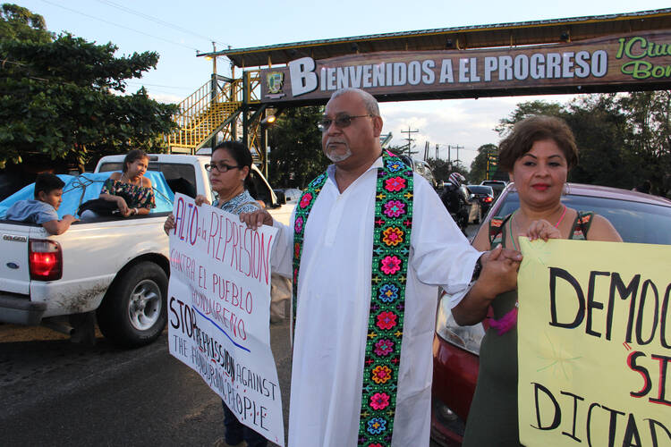 Ismael Moreno, S.J., (center) the director of Radio Progreso/Fundación Eric, joins demonstrators in El Progreso, Honduras, protesting the election of President Juan Orlando Hernandez in January 2018. Funding from Canada's Development and Peace agency for his media and human rights ministry had been in doubt. Photo by Kevin Clarke