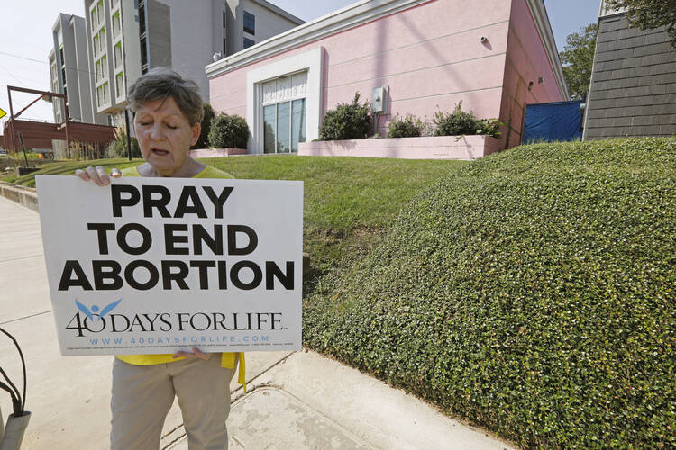 An abortion opponent outside the Jackson Womens Health Organization clinic in Jackson, Miss., on Oct. 2, 2019. (AP Photo/Rogelio V. Solis, File)