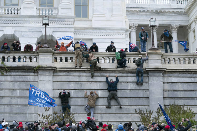Insurrectionists scale the west wall of the the U.S. Capitol in Washington on Jan. 6, 2021. (AP Photo/Jose Luis Magana, File)