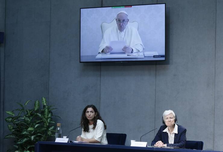 Pope Francis delivers a recorded message during a news conference to unveil a new platform for action based on his 2015 encyclical “Laudato Si'” at the Vatican on May 25. At the dais are Carolina Bianchi, who works with the Global Catholic Climate Movement, and Sister Sheila Kinsey, co-secretary of the Justice, Peace and Integrity of Creation Commission of the International Union of Superiors General. (CNS photo/Paul Haring)