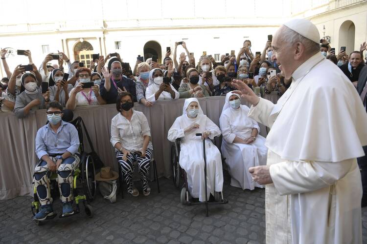 Pope Francis greets people during his general audience in the San Damaso Courtyard of the Apostolic Palace at the Vatican June 30, 2021. The pope continued his series of audience talks focused on the Letter to the Galatians and reflected on St. Paul's life and the power of God's grace. (CNS photo/Vatican Media)