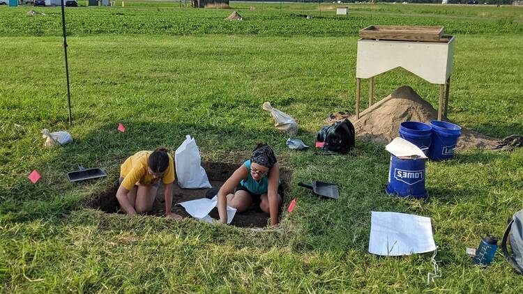 Field technicians dig at a former plantation