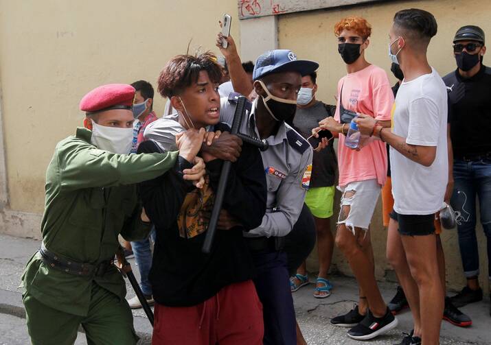 Police detain a person during protests in Havana July 11, 2021. Thousands of Cubans took to the streets to protest a lack of food and medicine as the country undergoes a grave economic crisis aggravated by the Covid-19 pandemic and U.S. sanctions. (CNS Photo/Reuters)