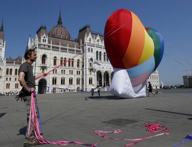 Activists erect a rainbow-colored heart in front of the parliament building in Budapest, Hungary, on July 8. The activists are protesting against the recently passed law that they say discriminates against L.G.B.T.Q. people. (AP Photo/Laszlo Balogh)