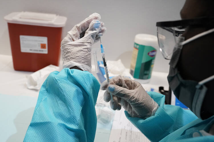 In this July 22, 2021 file photo, a health care worker fills a syringe with the Pfizer Covid-19 vaccine in New York. (AP Photo/Mary Altaffer, File)