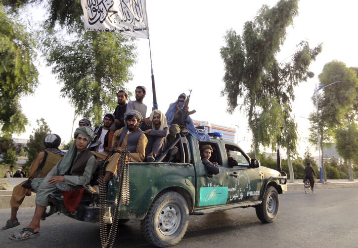 Taliban fighters patrol inside the city of Kandahar, southwest Afghanistan, on Aug. 15, 2021. (AP Photo/Sidiqullah Khan)