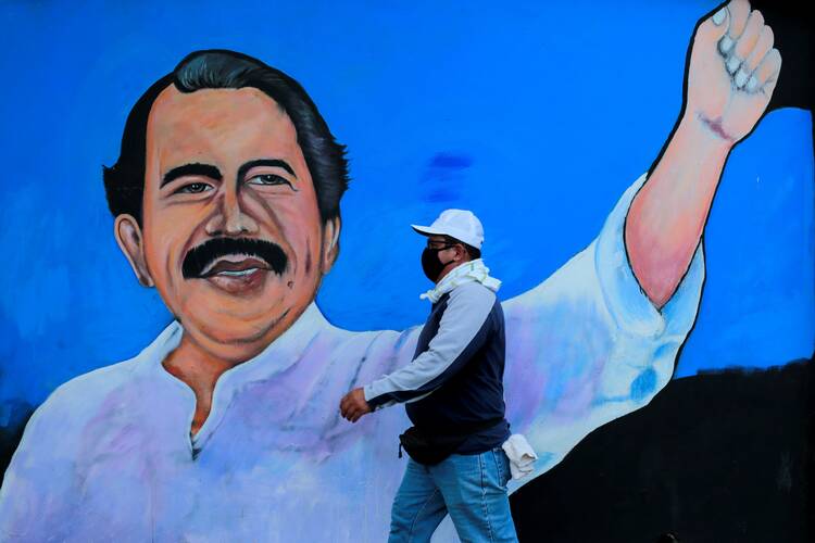 A man wearing a protective mask walks by a mural depicting Nicaraguan President Daniel Ortega in Managua March 30, 2020, during the COVID-19 pandemic. (CNS photo/Oswaldo Rivas, Reuters)