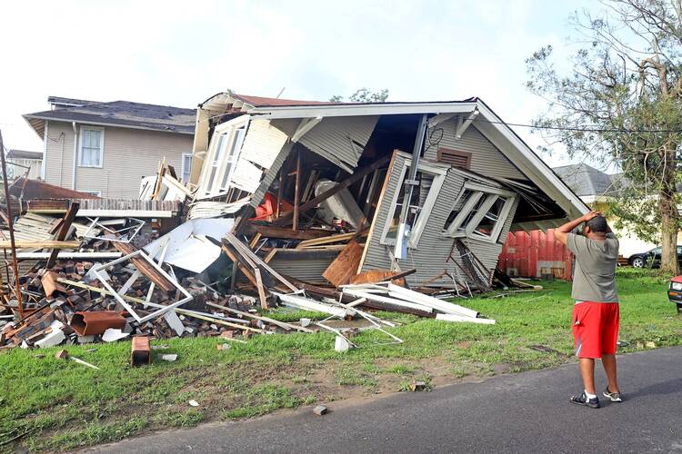 Dartanian Stovall of New Orleans, La., looks at the house that collapsed with him inside during the height of Hurricane Ida, Aug. 30, 2021.