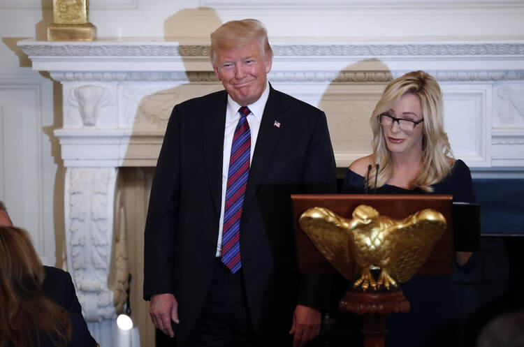 Former president Donald Trump at a lectern.