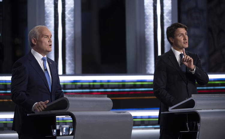 Conservative leader Erin O'Toole, left, and Liberal leader Justin Trudeau speak during the federal election French-language leaders debate, Wednesday, Sept. 8, 2021, in Gatineau, Que. Trudeau called the early election for Monday, Sept. 20 in hopes of winning a majority of seats in Parliament, but has faced criticism for calling a vote during a pandemic in order to cement his hold on power. (Justin Tang/The Canadian Press via AP)