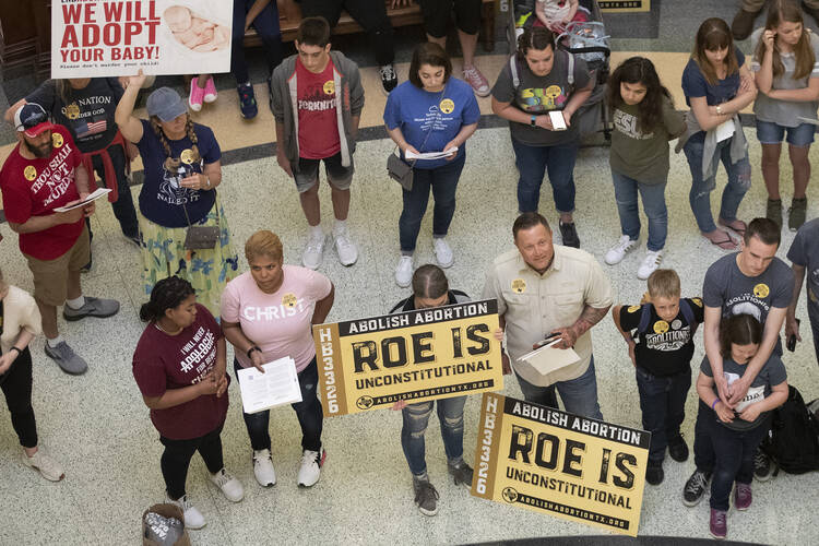 In this March 30, 2021, file photo, anti-abortion rights demonstrators gather in the rotunda at the Capitol while the Senate debated anti-abortion bills in Austin, Texas. Young people on social media have found a way to protest Texas' new law banning most abortions by focusing on a website established by the state's largest anti-abortion group that takes in tips on violations. (Jay Janner/Austin American-Statesman via AP, File)