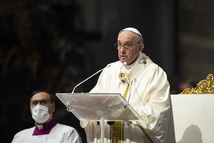 Pope Francis speaks at a clear lectern during a homily.
