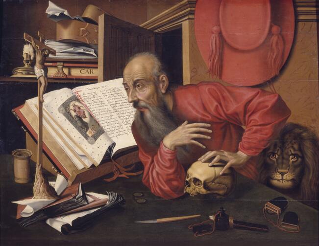A Northern Renaissance painting of St. Jerome, dressed in red and seated in front of a translated Bible.