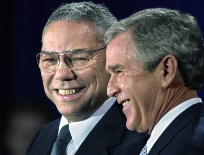 In this Dec. 16. 2000 file photo, President-elect Bush smiles as he introduces retired Gen. Colin Powell, left, as his nominee to be secretary of state during a ceremony in Crawford, Texas. (AP Photo/David J. Phillip)