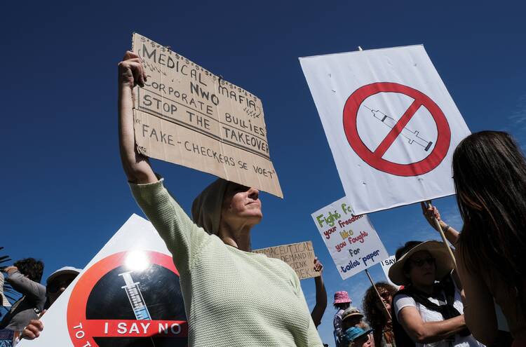 Anti-vaccine protestors hold placards during a march against COVID-19 vaccinations in Cape Town, South Africa