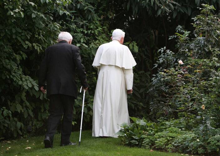 Monseigneur Georg Ratzinger and his brother, Pope Benedict XVI, take a walk through the garden of a house the pope owns in Pentling, near Regensburg, Germany, on Sept. 13, 2006.