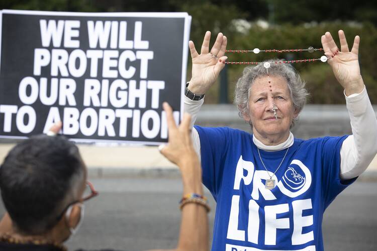 Pro-life advocates and supporters of legal abortion are seen near the U.S. Supreme Court building in Washington Oct. 4, 2021, the first day of the high court's new term. (CNS photo/Tyler Orsburn)