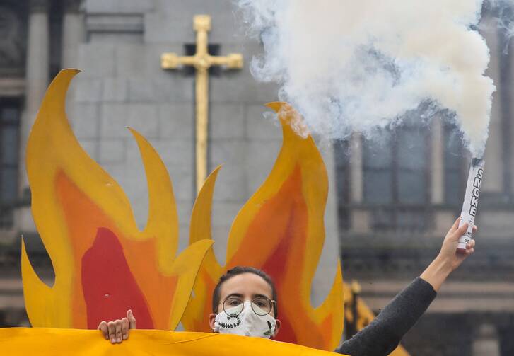 An activist takes part in a protest ahead of the 26th U.N. Climate Change Conference in Glasgow, Scotland, Oct. 28, 2021. (CNS photo/Russell Cheyne, Reuters)