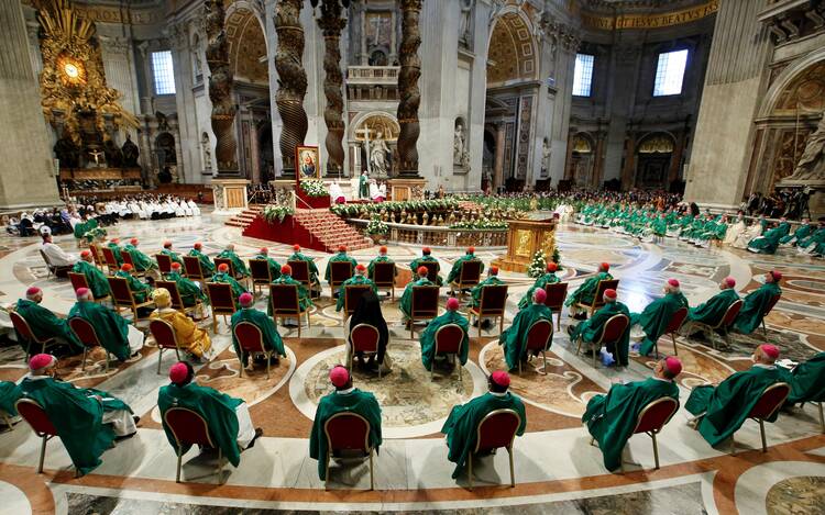 Bishops and cardinals are seated in a semicircle as Pope Francis gives his homily at the opening Mass of the synod.