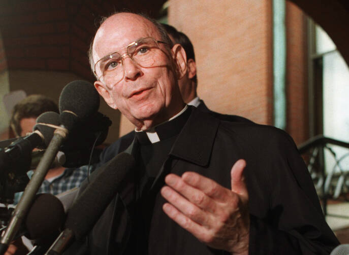 Cardinal Joseph Bernardin speaks with reporters on the steps of his Chicago residence just before his departure for Rome to meet with Pope John Paul II, Sept. 23, 1996.