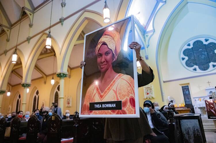 Theresa Wilson Favors, former director of the Office of Black Catholic Ministries for the Archdiocese of Baltimore, carries a portrait of Sister Thea Bowman.
