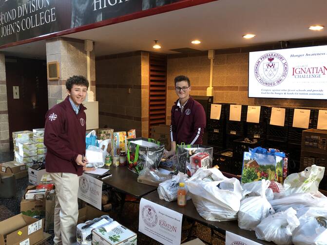Fordham Prep students collect donations for the Great Ignatian Challenge in 2019. The annual holiday food drive, which now takes place at 15 Jesuit schools, also raises money for financial assistance programs at thge participating schools. (Christopher Lauber/Fordham Prep)