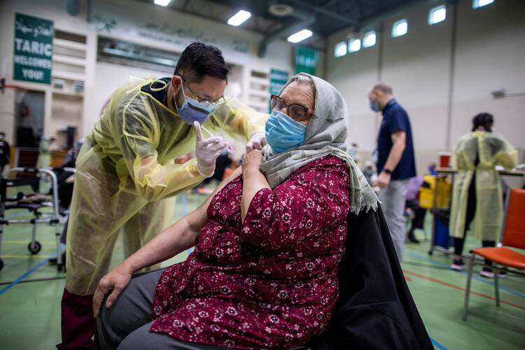 A woman in Toronto receives the Moderna COVID-19 vaccine at the Toronto and Region Islamic Congregation center April 1, 2021. (CNS photo/Carlos Osorio, Reuters)