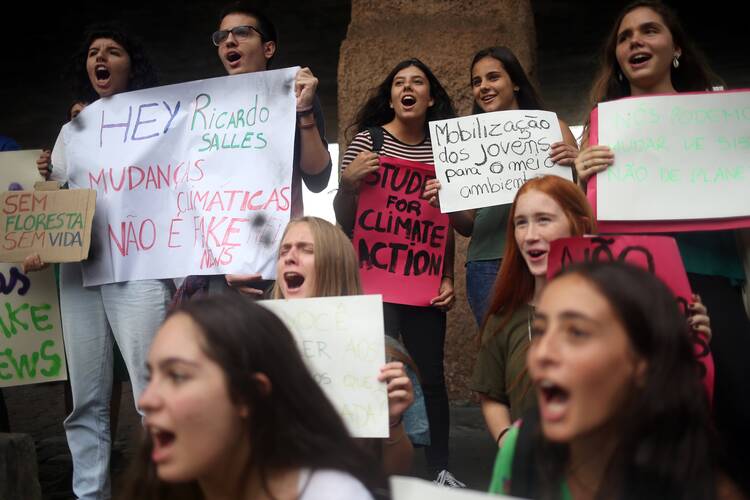 Students hold placards as they demonstrate to demand global action on climate change as part of the "Fridays for Future" movement in São Paulo March 15, 2019. The banner reads: "Hey Ricardo Salles, climate change is not fake news." The Pontifical Academy of Social Sciences hosted a workshop Sept. 13-14 on the "post-truth" era in communications. (CNS photo/Amanda Perobelli, Reuters)