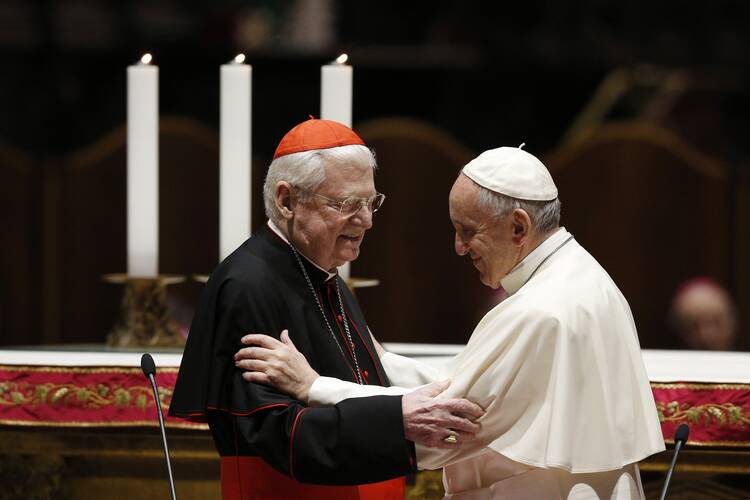 Pope Francis embraces Cardinal Angelo Scola of Milan during a meeting with clergy and religious at the cathedral in Milan.