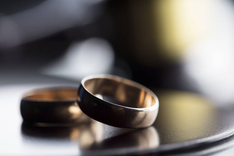 Two wedding rings laying on a table.