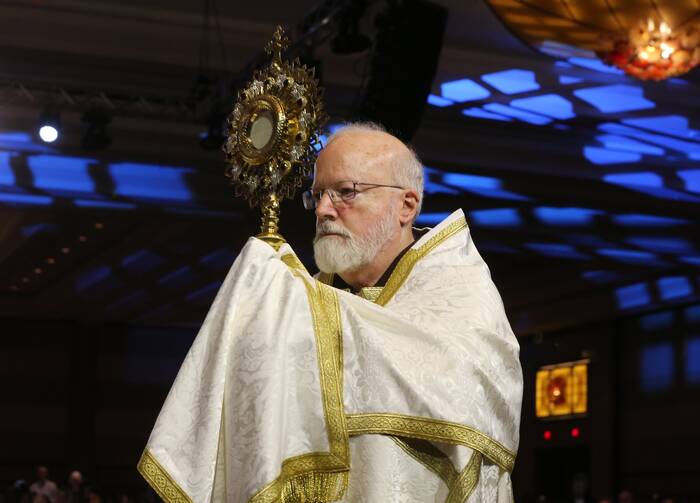 Boston Cardinal Sean P. O’Malley carries a monstrance during eucharistic adoration.