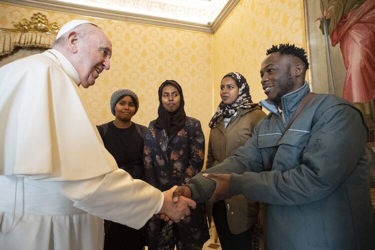 Pope Francis greets asylum-seekers transferred from Cyprus to Italy with his help, during a meeting at the Vatican Dec. 17, 2021. The migrants are being assisted by the Vatican and the Community of Sant'Egidio. (CNS photo/Vatican Media)