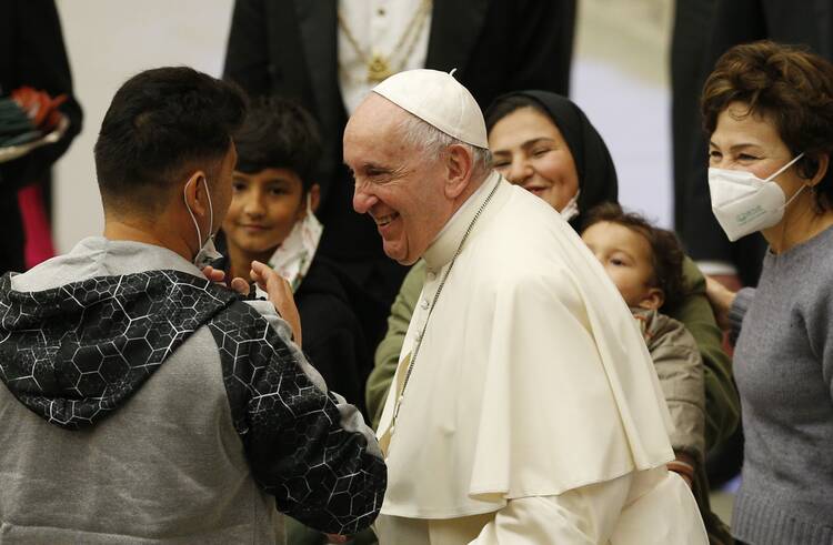 Pope Francis greets people during his general audience in the Paul VI hall at the Vatican Dec. 22, 2021.