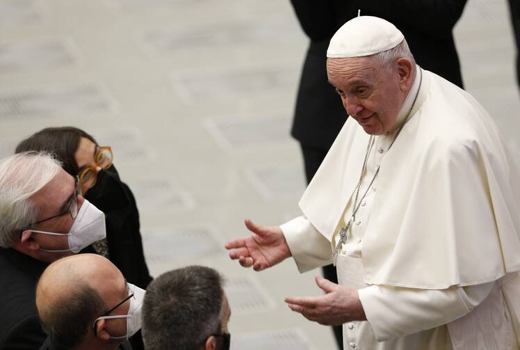 Pope Francis greets people during his general audience in the Paul VI hall at the Vatican Jan. 12, 2022.