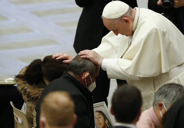 Pope Francis blesses people during his general audience in the Paul VI hall at the Vatican Jan. 19, 2022.