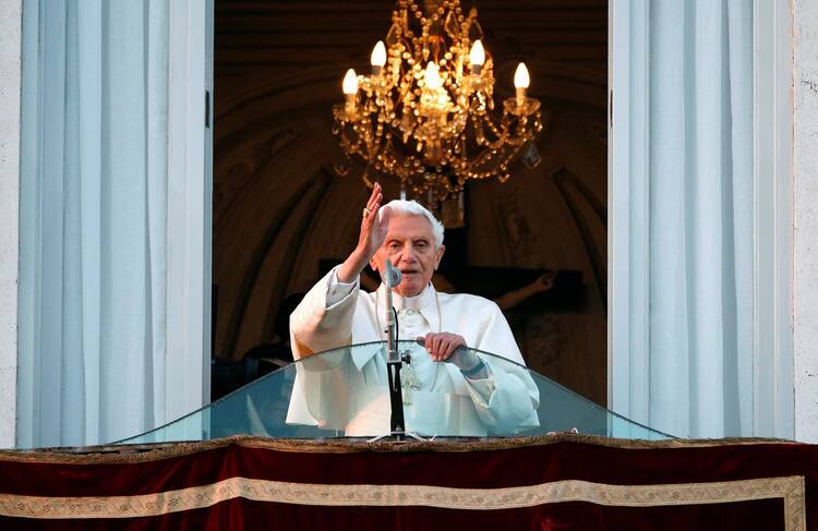 Pope Benedict XVI blesses the faithful from the balcony of his summer residence on the day of his resignation in Castel Gandolfo, Italy, on Feb. 28, 2013.