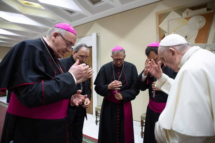Pope Francis and four French bishops make the sign of the cross during silent prayer for the victims of abuses committed by members of the clergy, prior to the pope's general audience at the Vatican on Oct. 6, 2021. The bishops were visiting Rome following a report on sexual abuse in France that estimates more than 200,000 children were abused by priests since 1950, and more than 100,000 others were abused by lay employees of church institutions. (CNS photo/Vatican Media)