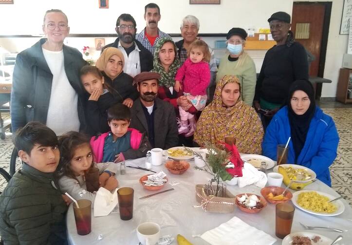 Staff and volunteers join a family arriving from Afghanistan at the Holy Cross Retreat Center in Las Cruces, N.M. (Photo courtesy of Holy Cross Retreat Center)