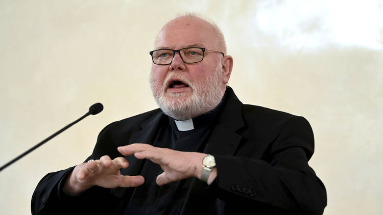 Cardinal Reinhard Marx comments in a press conference, in front of a microphone, on the expert report on sexual violence against children and young people in the Catholic Archdiocese of Munich and Freising in Munich, Germany.