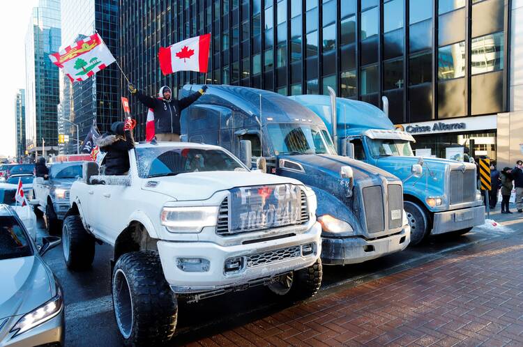 Trucks block a downtown road as truckers and supporters take part in a convoy to protest the COVID-19 vaccine mandates for cross-border truck drivers, in Ottawa, Ontario, Jan. 29, 2022. (CNS photo/Patrick Doyle, Reuters)