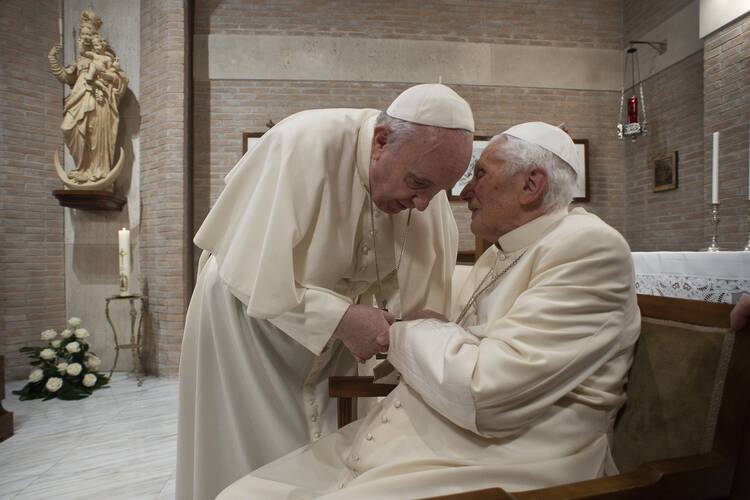 Pope Francis visits with Pope Benedict XVI at the retired pope's residence after a consistory at the Vatican in this Nov. 28, 2020, file photo.