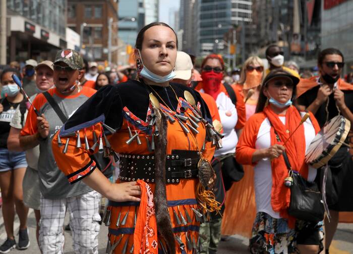 Indigenous performer Danielle Migwans attends a march on Canada Day in Toronto on July 1, 2021, after the discovery of hundreds of unmarked graves on the grounds of two former residential schools for Indigenous children in Canada. More than two dozen Indigenous delegates, accompanied by a handful of Canadian bishops, plan to meet with Pope Francis at the Vatican March 28-April 1. (CNS photo/Carlos Osorio, Reuters)
