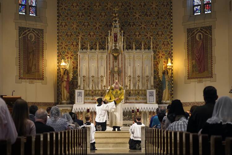 Father Stephen Saffron, parish administrator, elevates the Eucharist during a Tridentine Mass at St. Josaphat Church in the Queens borough of New York City.