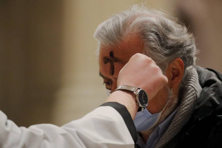 A penitent receives ashes at St. Patrick's Cathedral in New York City during Ash Wednesday Mass Feb. 17, 2021, amid the coronavirus pandemic.