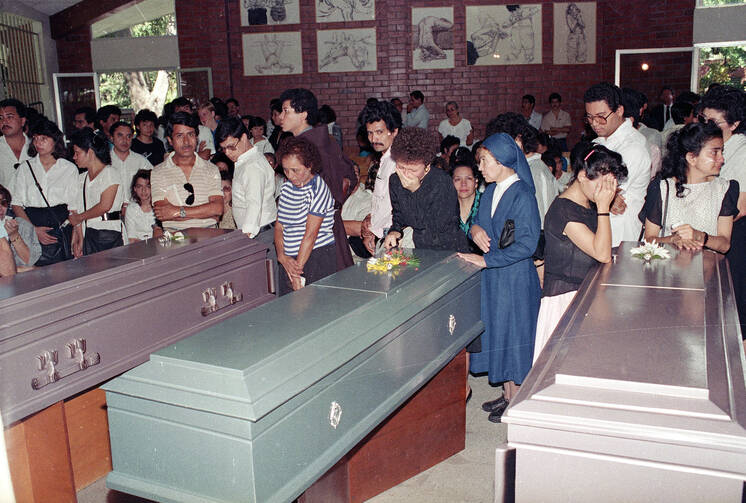 People gather to mourn the death of six Salvadoran Jesuits, on November 18, 1989, in San Salvador, El Salvador (AP Photo/Luis Romero).