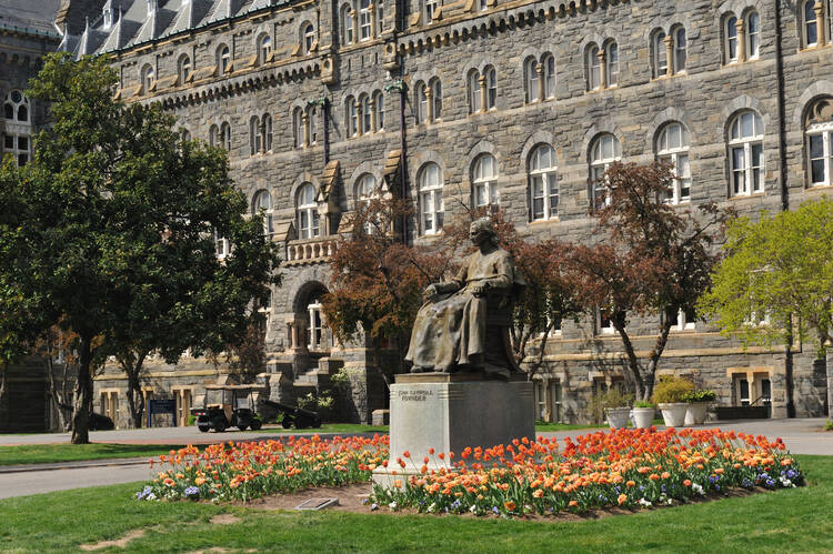 Georgetown University’s description of its philosophy program promises to equip students "with important skills for living with themselves from day to day.” (Photo of John Carroll statue in front of Healy Hall from iStock/aimintang)